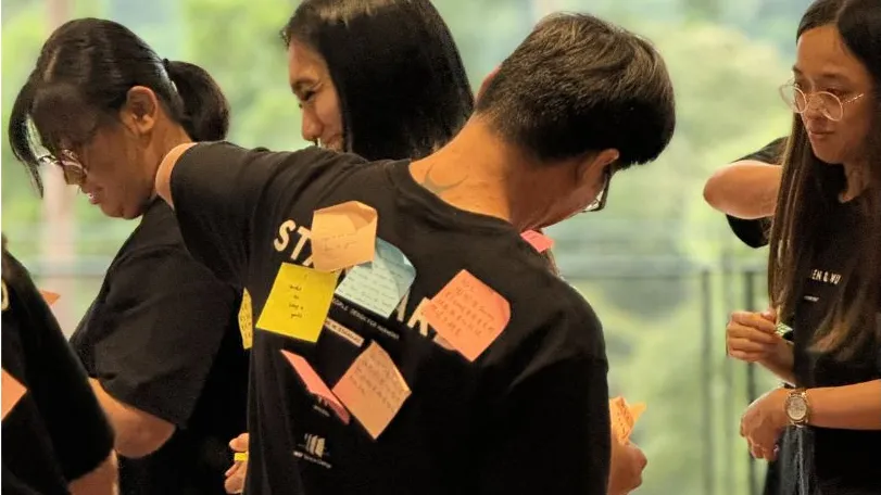 Participants working together on a sticky-note activity outdoors