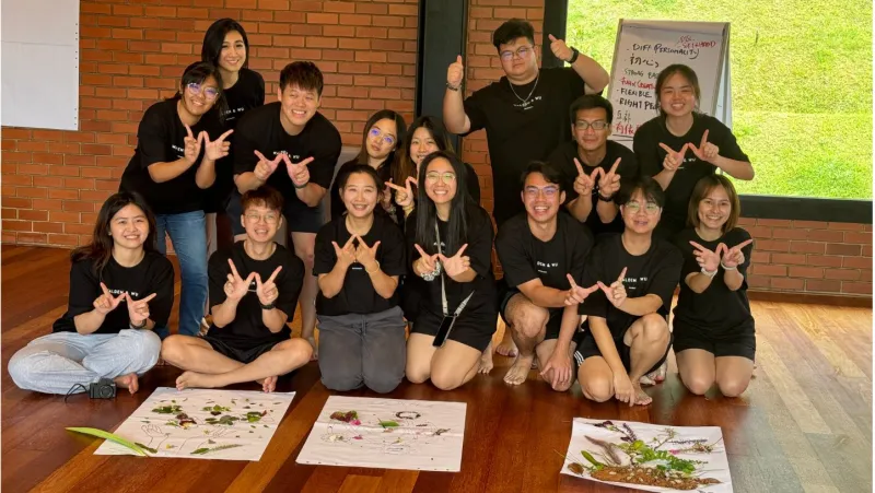 A seated team photo after a creative group activity