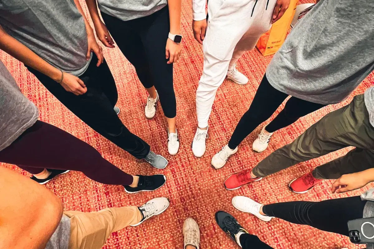 Participants standing in a circle during a team building workshop